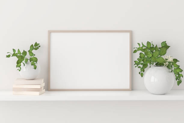 istock Empty picture frame mockup on a shelf with books and plants. 1332269686