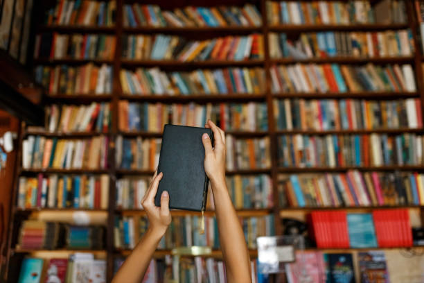 istock Young female student study in the library holding book , education concept 1332271694