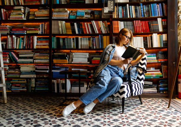 istock Young female student study in the library holding book , education concept 1332272894