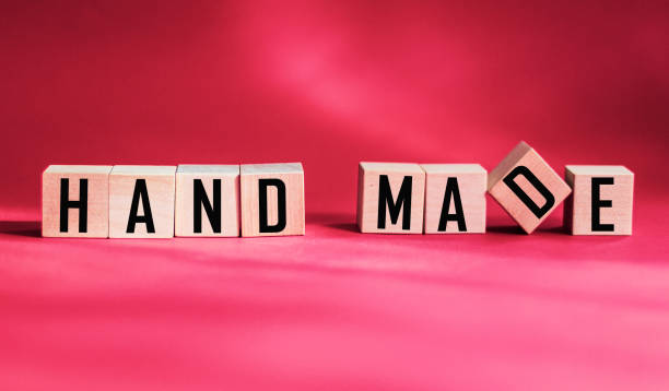 istock Handmade, motivational phrase on wooden cubes with red background 1332273978