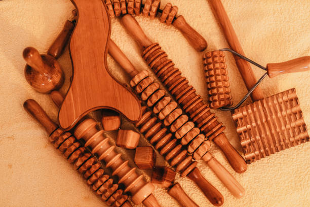 Wooden rolling pins and massagers prepared for maderotherapy on the massage table