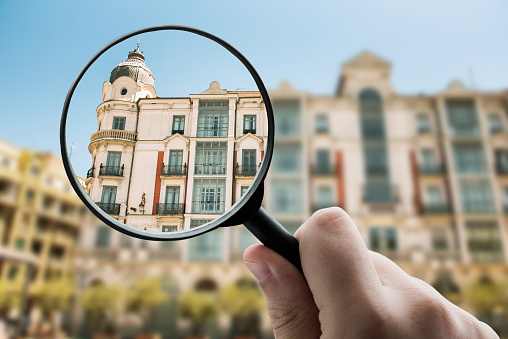 Magnifying glass focusing a residential building
