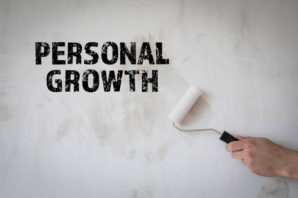 istock Personal Growth concept. Man with a roller of paint and white wall 1332276479