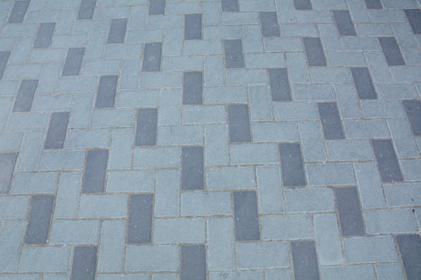istock Stone pavement texture. Granite cobblestoned pavement background. Gray brick stone background. 1332276950