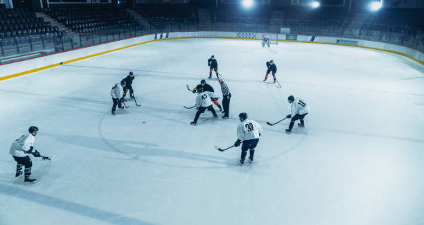 Ice Hockey Rink Arena: Great Team Attacks, Plays Pass Using Tactics and Creative Strategy. Player Masterful Dribbles. Beautiful Energetic Game from Team. High Angle Shot