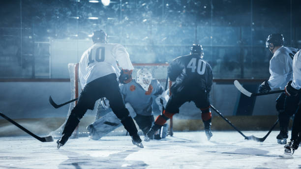 istock Ice Hockey Rink Arena: Professional Forward Player Masterfully Dribbles, Breaks Defense, Hitting Puck with Stick. Important and Tension Moment. 1332278090