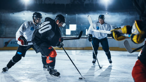 istock Ice Hockey Rink Arena: Professional Defender Player Attacks, Pushing Attacker Aggressively, Trying to take the Puck. Competitive Intense Game with Skill, Speed, Energy, Power. 1332278091