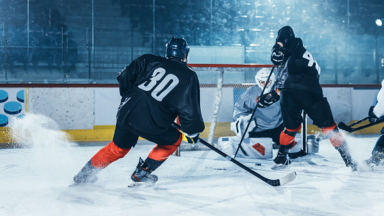 Ice Hockey Rink Arena: Professional Forward Player Attacks, Shows Expert Stickhandling, Dribbles, Handling Puck with Hockey Stick Beautifully, Defense Unable to Intercept.