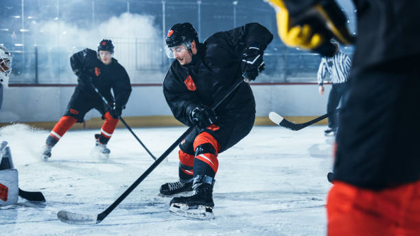 istock Ice Hockey Rink Arena: Professional Defender Player Attacks, Pushing Attacker, Trying to take the Puck. Competitive Game with Skill, Speed, Energy, Power. 1332278207