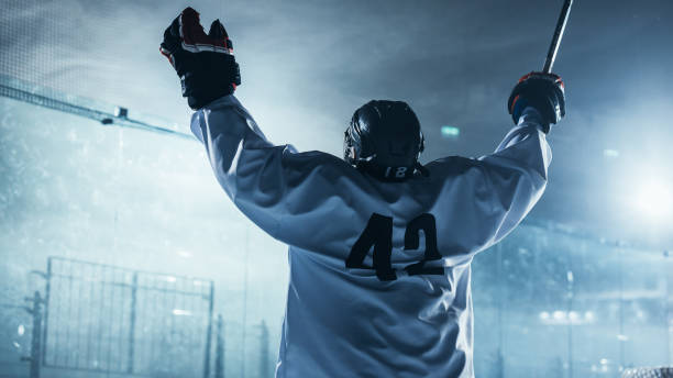 professional ice hockey player celebrating victory, raising arms. - clothing team sport serious viewpoint imagens e fotografias de stock
