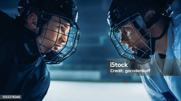 Ice Hockey Rink Arena Game Start Two Professional Players Aggressive Face Off Sticks Ready Intense Competitive Game Wide Of Brutal Energy Speed Power Professionalism Closeup Portrait Shot Stock Photo - Download Image Now
