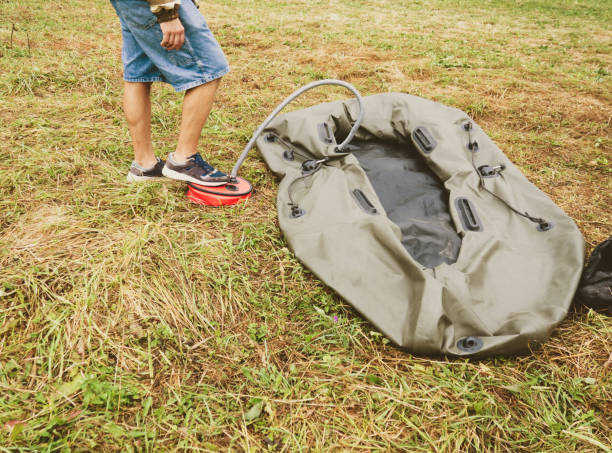 istock a man inflates a rubber boat with a pump 1332278312