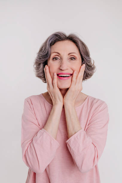 istock Happy stylish mature woman on light grey background 1332282657