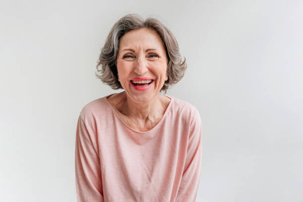 istock Happy stylish mature woman on light grey background 1332282834