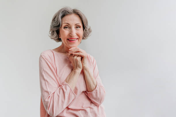 istock Happy stylish mature woman on light grey background 1332282873
