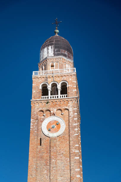 Chioggia, Italy – 09.07.2021: Tourists and residents in front of bell tower the Chioggia Cathedral dedicated to St. Mary of the Assumption is the main place of worship in city
