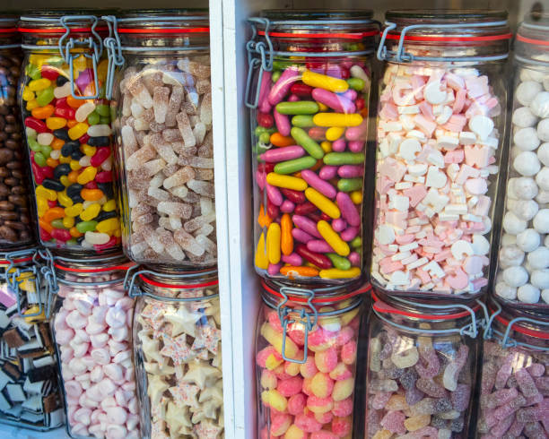 Jars of Sweets in a Shop Window Close-up of jars of sweets in a shop window. old candy store stock pictures, royalty-free photos & images