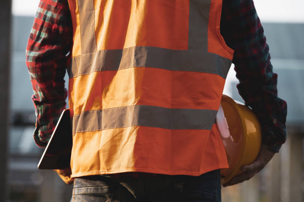 istock Behind the workers with tablets and helmets at a construction site,Engineer holding helmet, 1332286137