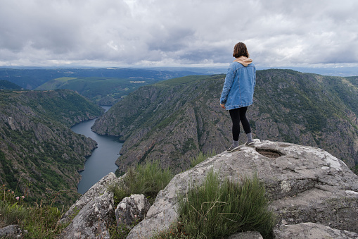 Woman admiring the landscape of Galicia, Spain. Ribeira Sacra.