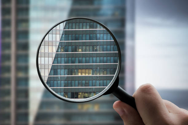 istock Magnifying glass focusing a modern office building facade 1332288900