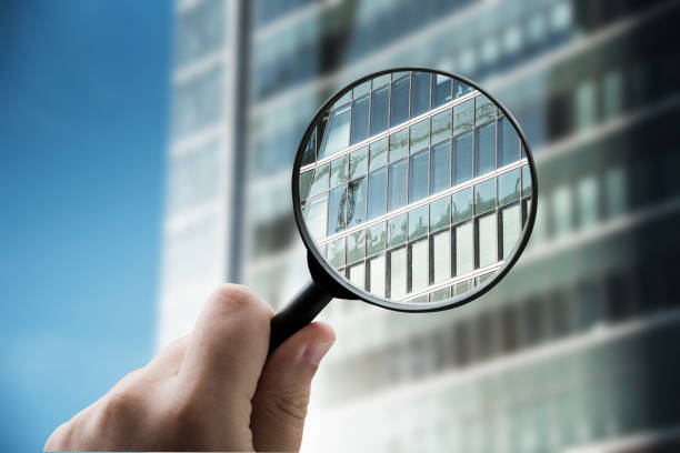 istock Magnifying glass focusing a modern office building facade 1332288937