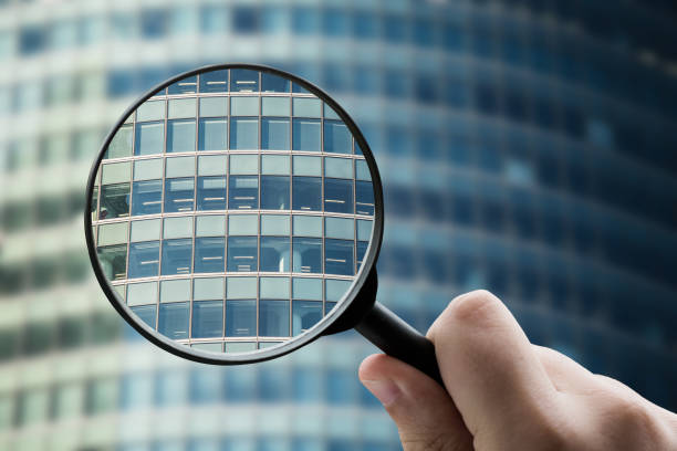 istock Magnifying glass focusing a modern office building facade 1332288983