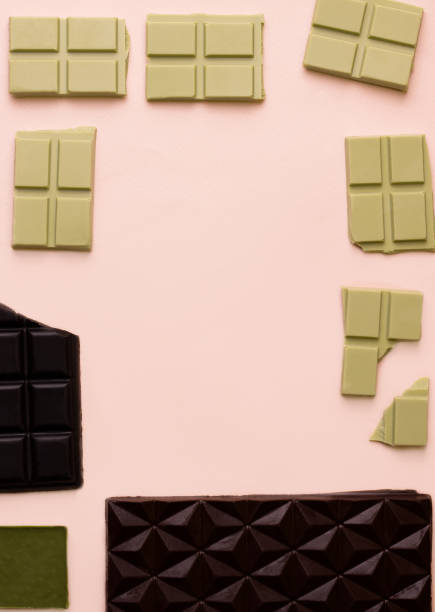 istock Different bars of chocolate on a pink background. View from above 1332291344
