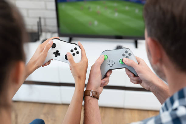 istock Couple playing games on console, gamepad in hands 1332291425