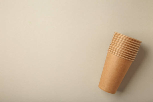 istock Disposable paper cups on grey background. Coffee concept. 1332295162