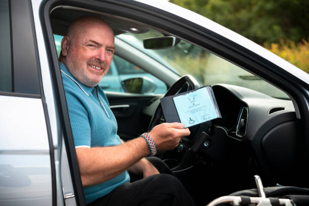istock Mature Man Showing His Disabled Badge 1332296752
