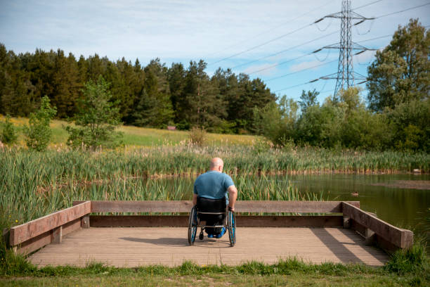 istock Mature Man Using a Wheelchair Enjoying the Views 1332296921