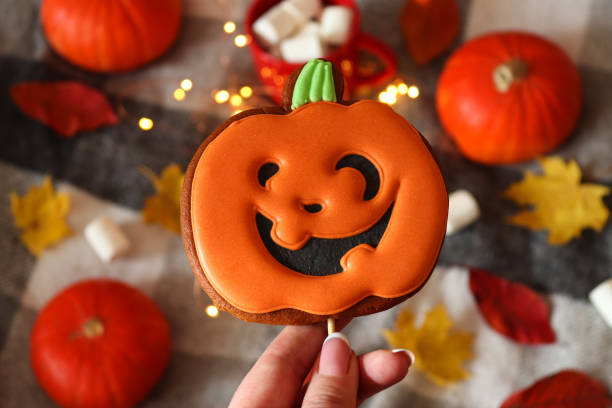 istock Funny Jack O Lanterns pumpkin shaped cookie for Halloween. Selective focus. Top view 1332300841
