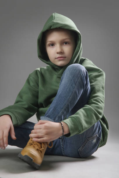 istock Studio portait of handsome schoolboy on grey background. 1332303601