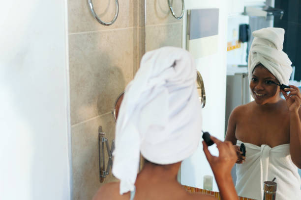 istock Woman applying makeup in the bathroom. 1332303634
