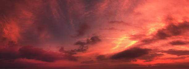 istock Horizontal panorama of a dramatic red black glowing cloudy sky at sunset. Sky texture. Abstract nature background 1332307094