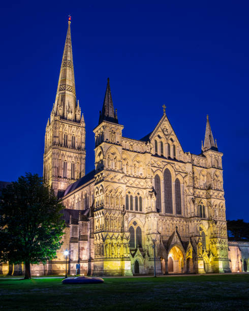 A dusk-time view of the stunning Salisbury Cathedral in the city of Salisbury in Wiltshire, UK.