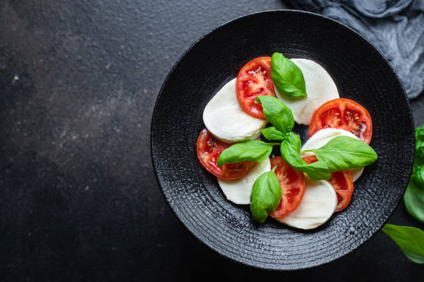 istock caprese salad mozzarella cheese, tomato basil leaf italian snack copy space food background rustic. top view keto or paleo diet veggie vegetarian food 1332308762