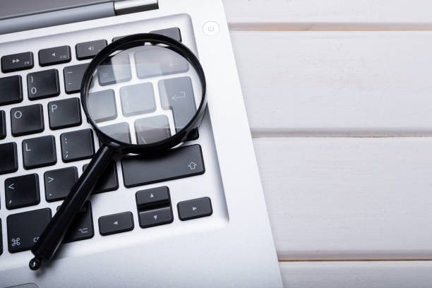 istock magnifier glass lies on laptop keyboard 1332308896
