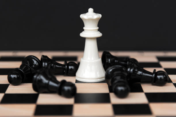 istock White Chess King with Fallen Black Chess Pawn 1332315193