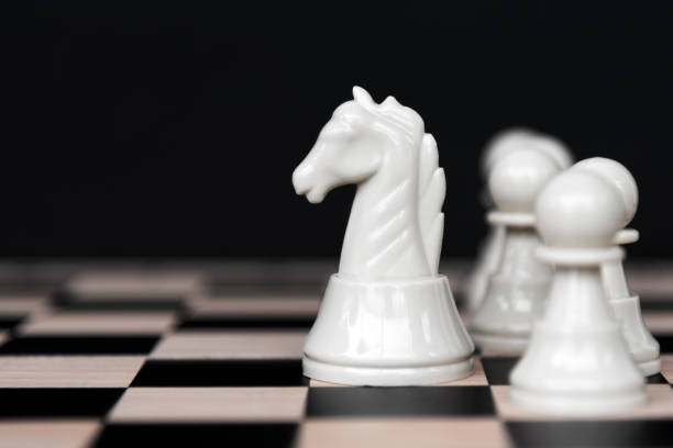 White Chess Pieces on Black Background