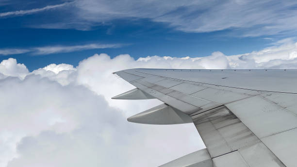 istock Airplane wing in the clouds 1332316578