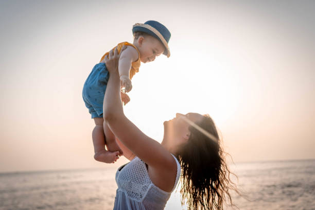 istock Mother and baby on the beach 1332319580