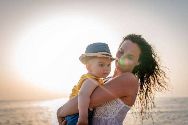 istock Mother and baby on the beach 1332319651