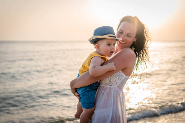 istock Mother and baby on the beach 1332319732