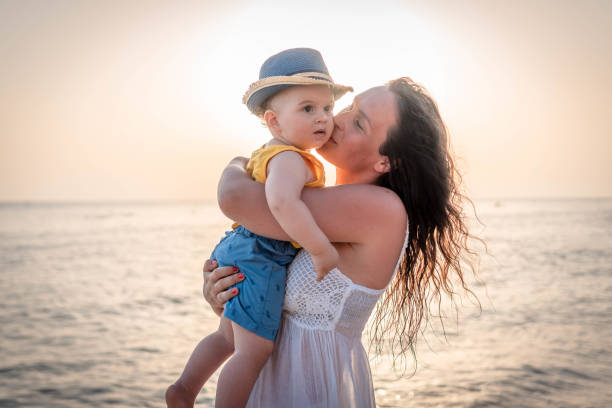 istock Mother and baby on the beach 1332319770