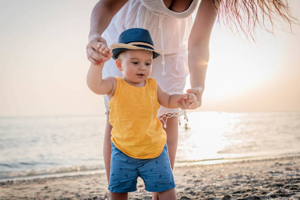 istock Mother and baby on the beach 1332319948