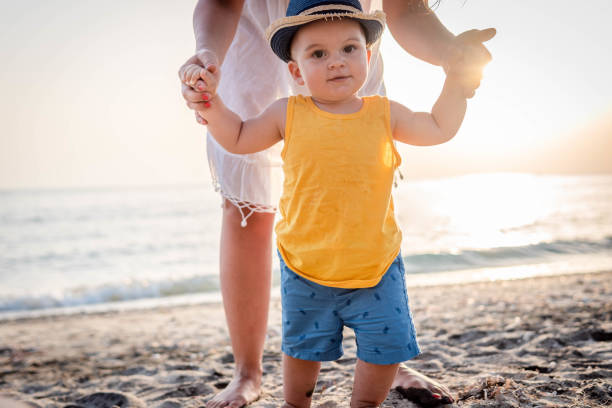 istock Mother and baby on the beach 1332319962