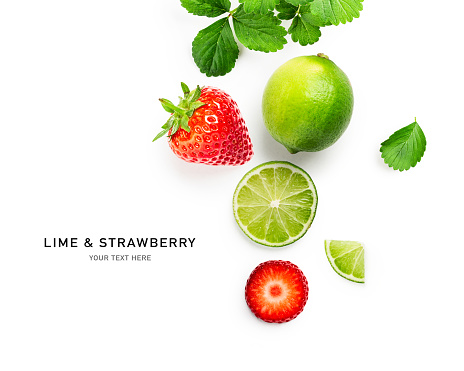Fresh lime fruit and strawberry creative layout isolated on white background. Healthy eating and food concept. Citrus fruits and berries composition. Top view, flat lay, design element
