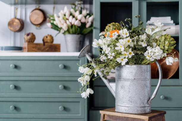 Vintage watering can filled with different fresh flowers