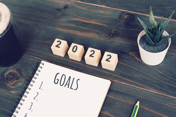 istock 2022 goals text on notepad with coffee cup and pen on wooden desk 1332325764